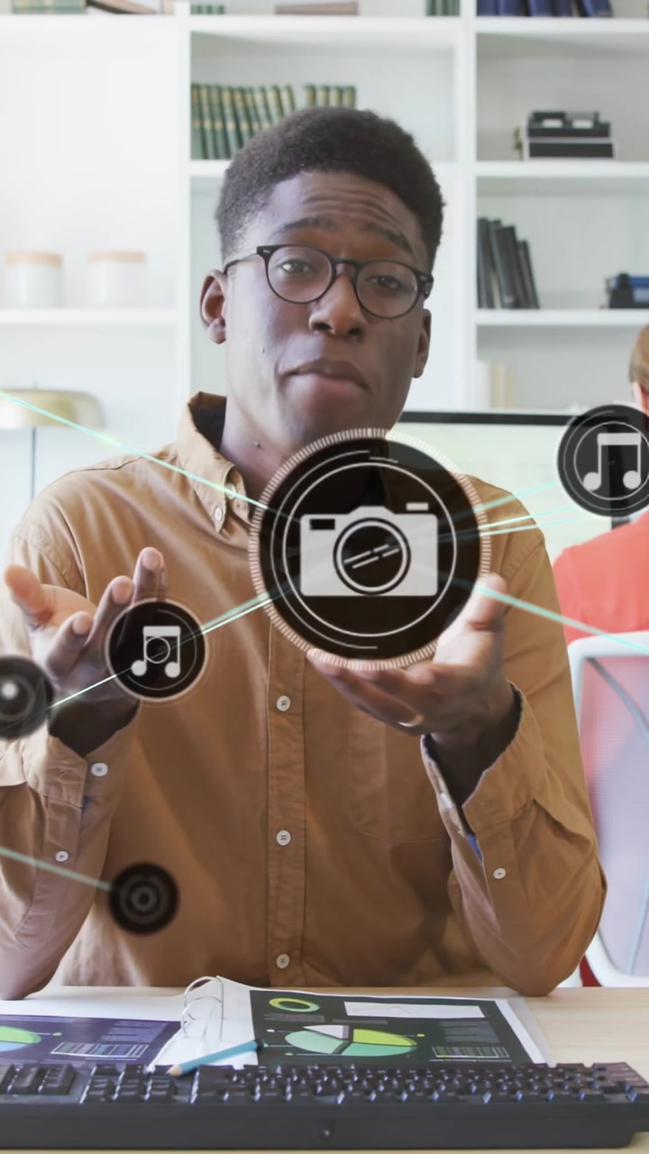 Vertical video: Man addressing cam, lifting charts and sparking music and cam icons for business
