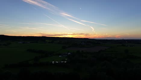 horizon and skyline of colour and drama over dark settlement below