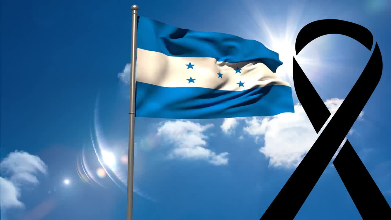 Waving Honduras flag with black ribbon against bright blue sky