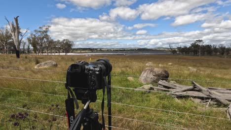 camera capturing changing skies over a field