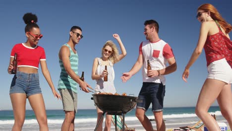 Young-adult-friends-having-a-barbecue-on-a-beach-4k