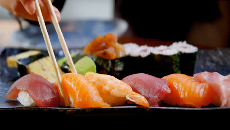 woman having sushi in restaurant 4k