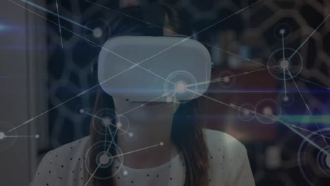 Animation-of-network-of-connections-over-caucasian-woman-using-vr-headset