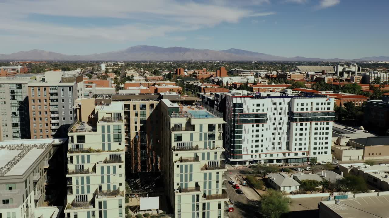 Modern student dorms near University of Arizona in Tucson, drone circling. Buildings with rooftop swimming pools