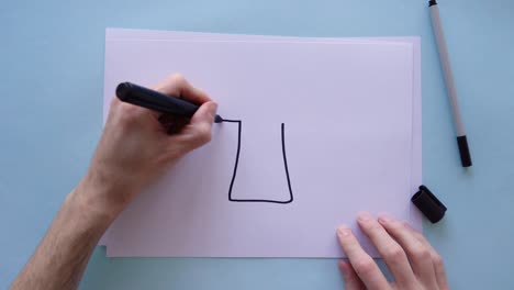 drawing an arrow pointing upwards on a piece of paper