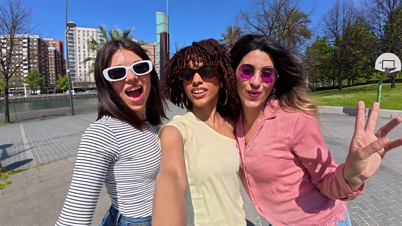 Group selfie of three friends in an urban setting