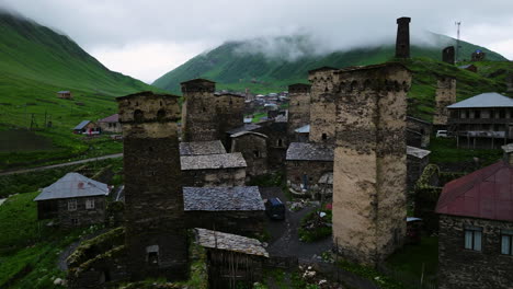 defensive towers on the stone houses at ushguli village on rainy weather in svaneti, georgia