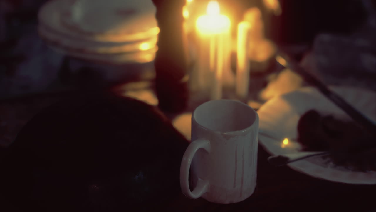 Warm glow of candlelight illuminating a quiet evening table setting