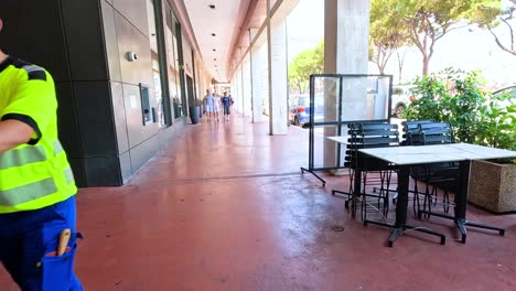 a worker moves a cart along a pathway