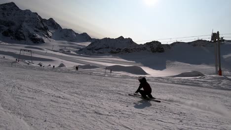 glacier skiing on a easy ski slope with a beautiful view on the wild mountain range in the alps