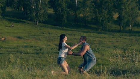 long haired girl runs to man and jumps with laughter