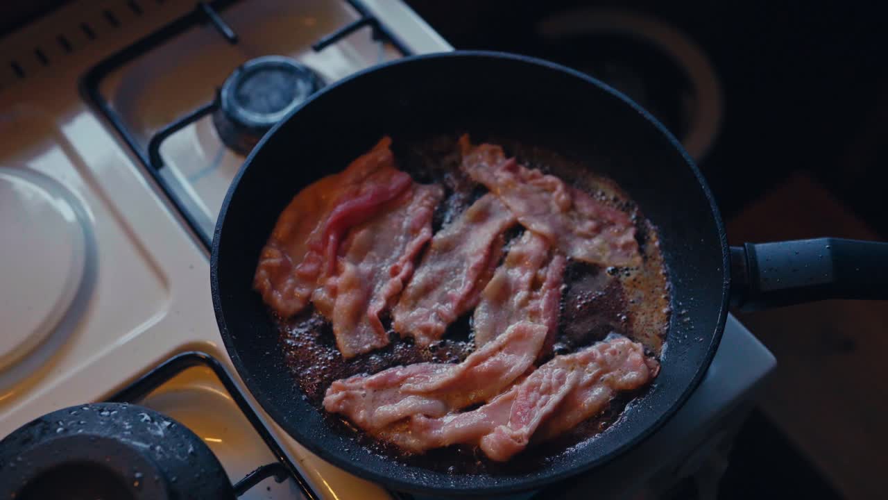 Cooking Fried Bacon On The Kitchen Stove - Breakfast Meal. - high angle shot