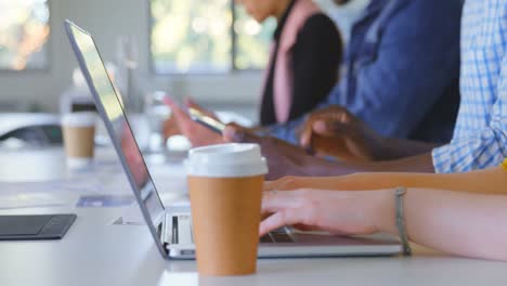 side view of mixed race business team working on multimedia devices in modern office 4k