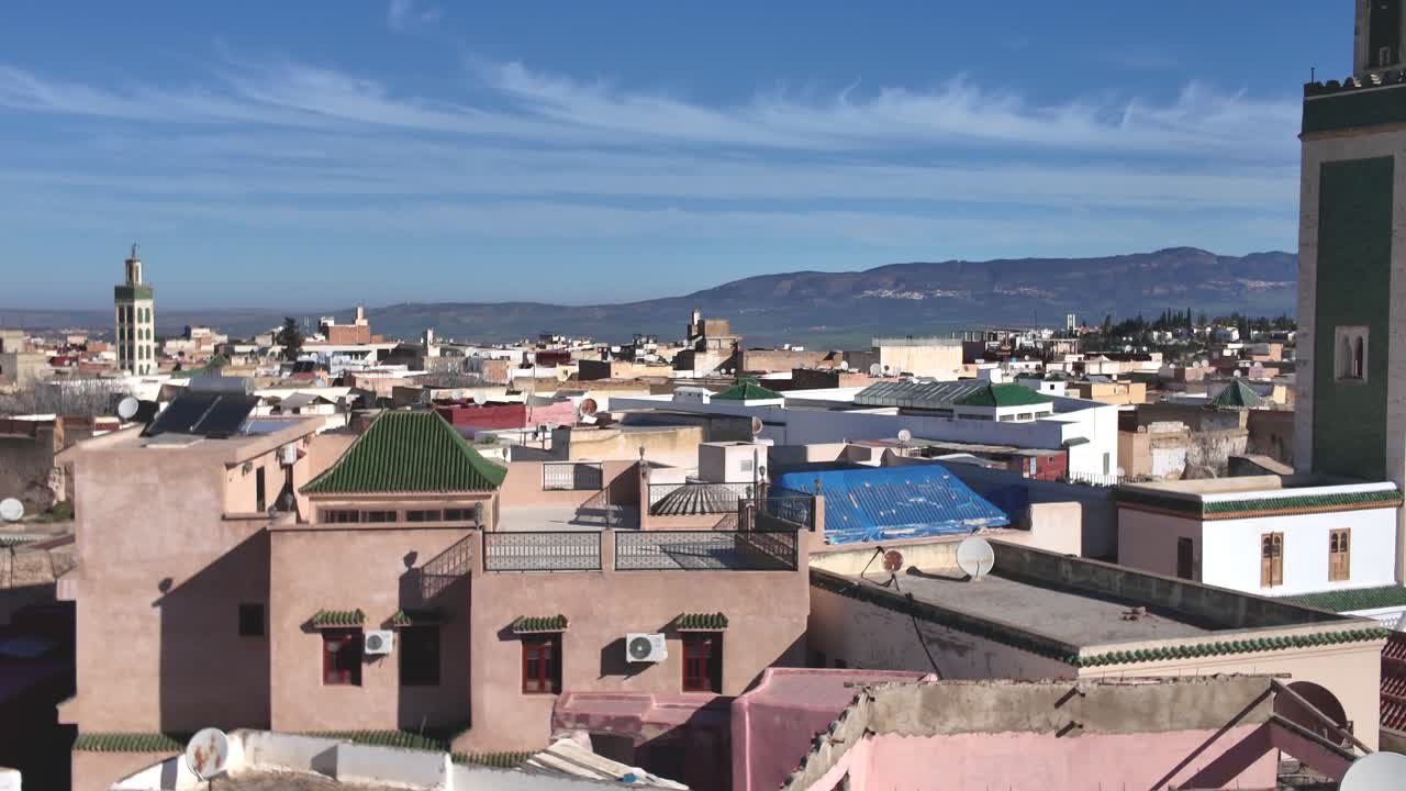 Panoramic view of Great Mosque of Meknes with cityscape and mountains, Morocco