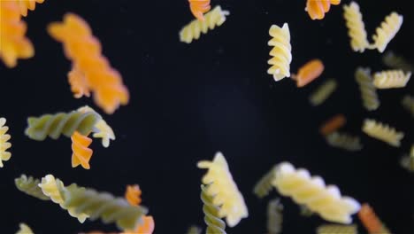 flying pasta on black background