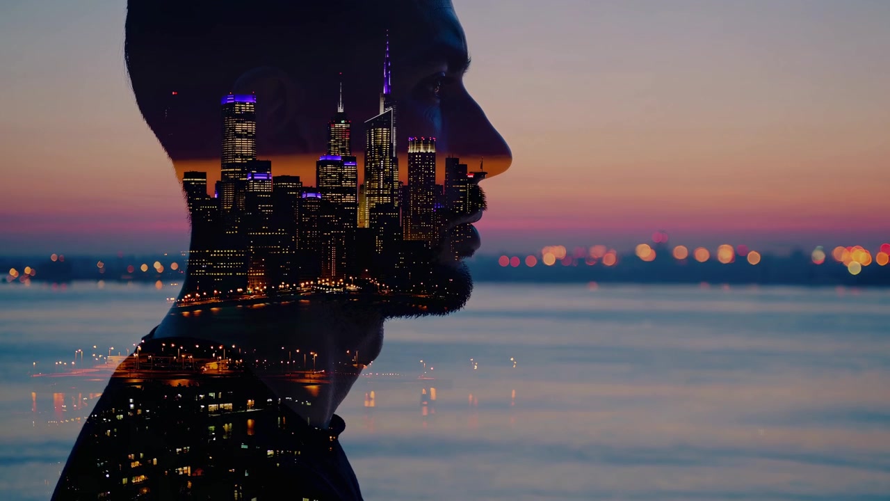 Double Exposure of Man's Silhouette with City Skyline at Sunset