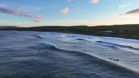 dunbar's sunset surfing session: the scottish beach experience at thorntonloch on the north sea, scotland, uk