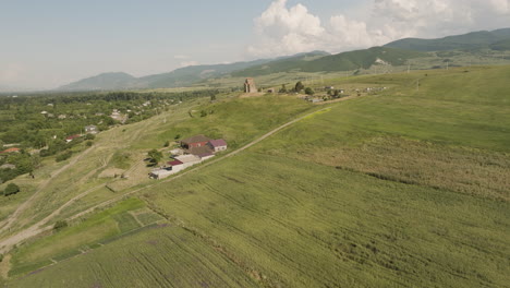 orthodox samtsevrisi church in green field countryside of georgia