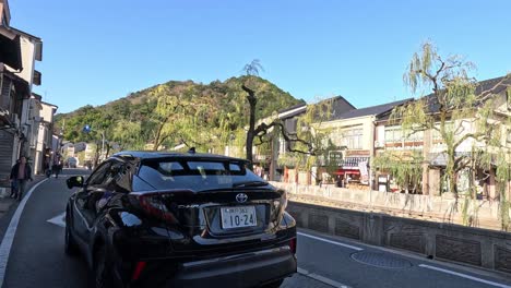 car driving through a picturesque town street