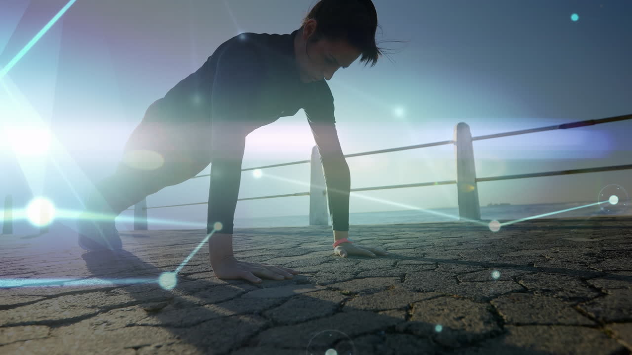 Animation of network connecting dots, bright light, caucasian woman doing pushups on pier at beach