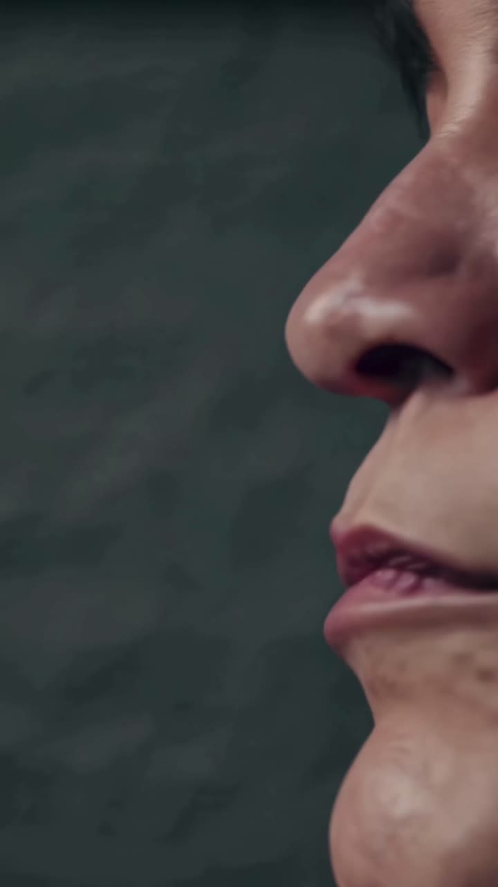 Close-up side angle of a person's lips and nose, capturing detailed skin texture