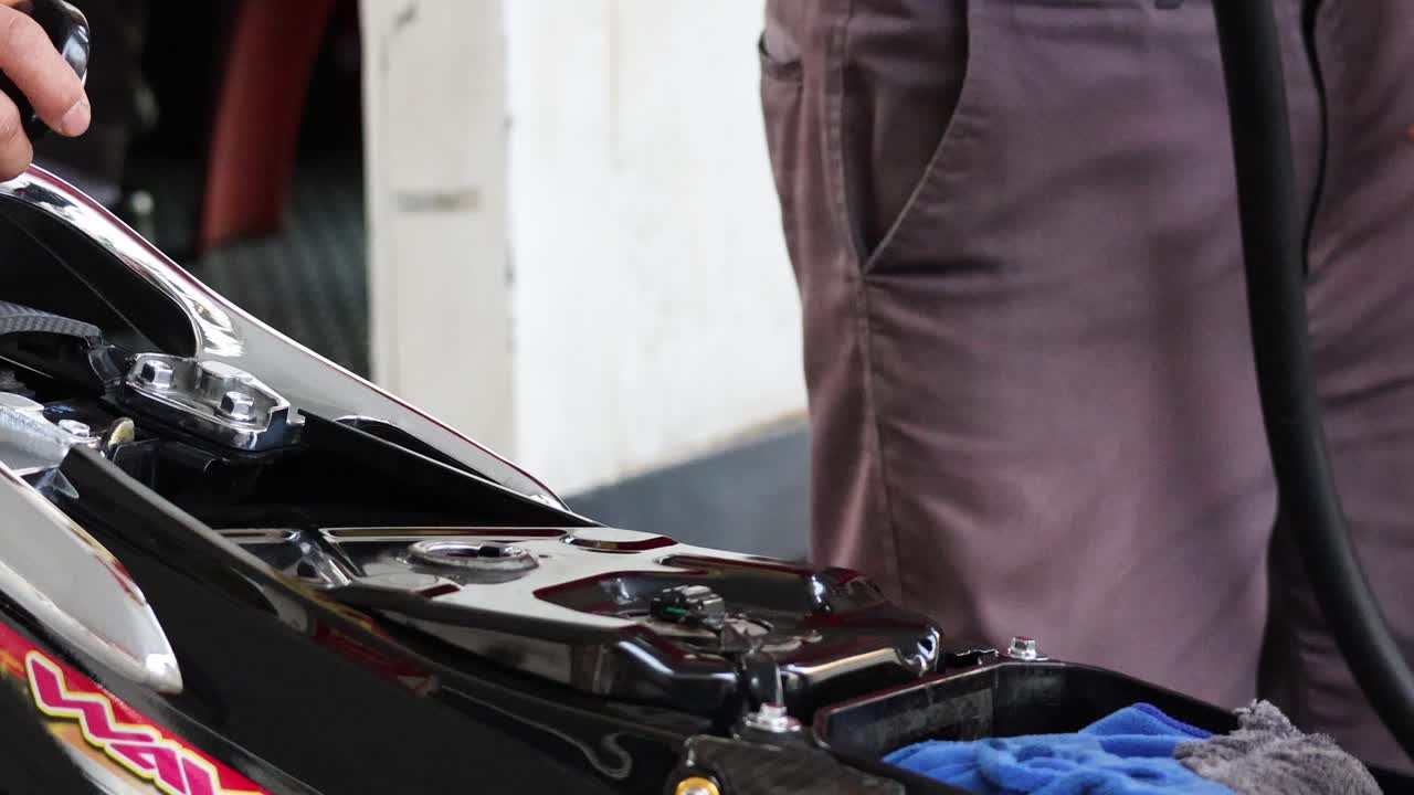 오토바이 크 에 가솔린 을 채우고 있는 사람