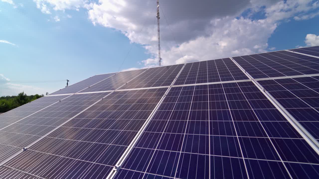 Close-up solar panel at sunlight. Alternative source of energy. Innovative solar cell panel under the sky on the field. Photovoltaic system.