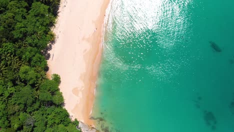 orbit drone shot of the pristine beachfront of leam singh, an untouched piece of paradise on the west coast of phuket island in the southern part of thailand