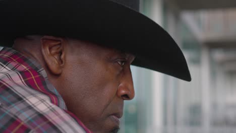 side portrait shot of black man with cowboy hat