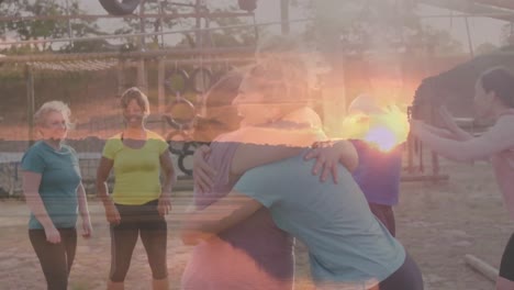 animation of sunset over diverse women at obstacle course embracing