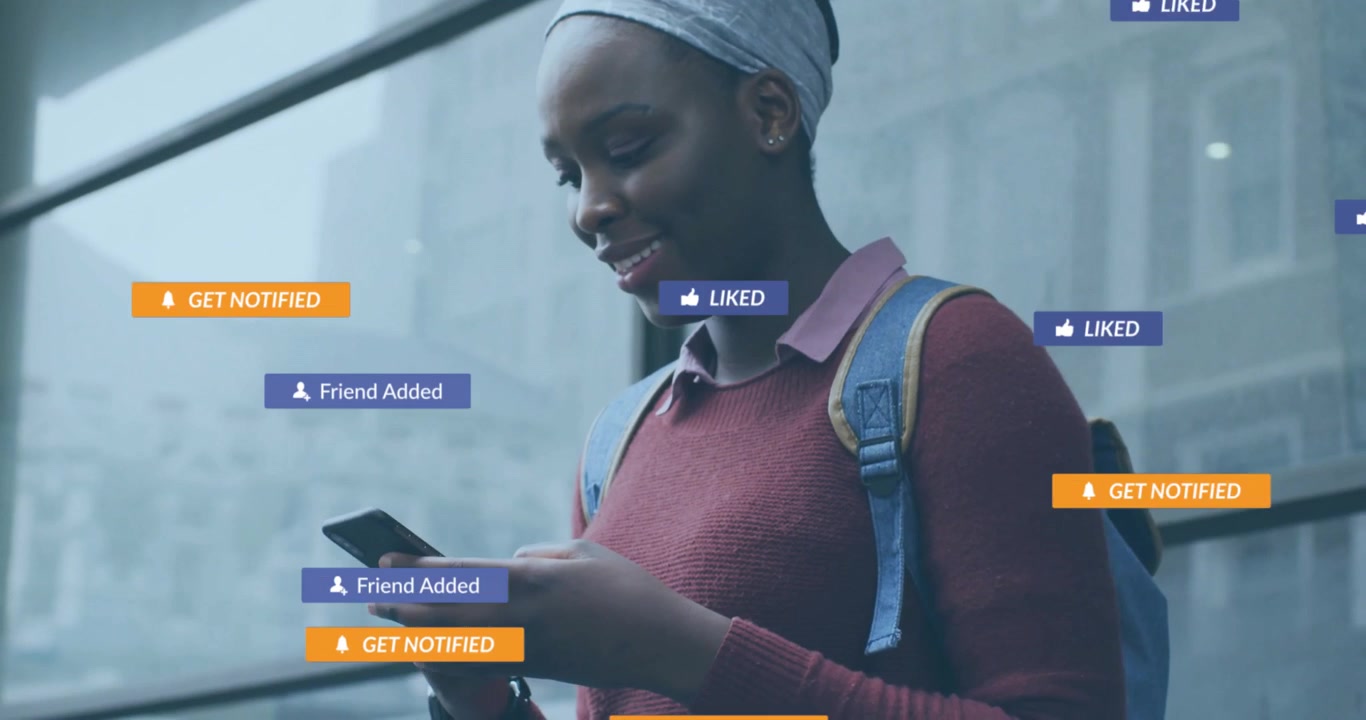 Student tapping smartphone and activating floating send message, subscribe, like icons in tech demo