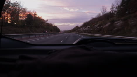 A-sunset-is-beginning-to-show-through-from-the-back-of-a-car-window