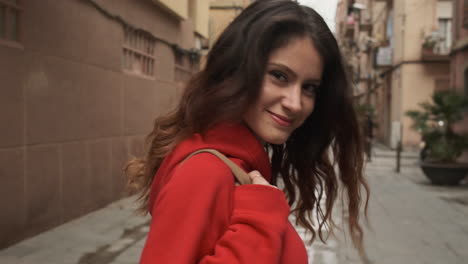 young girl smiling at the camera while walking in the street