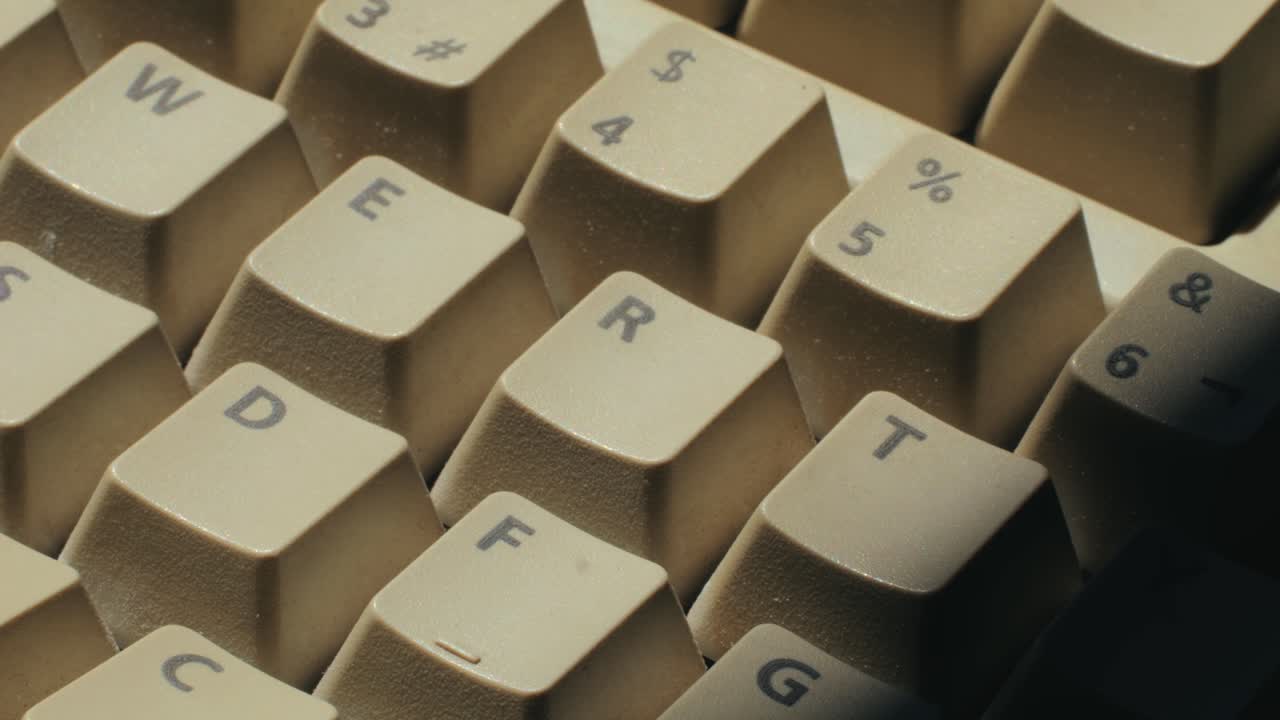 Man working and gaming on retro computer PC, IT engineer with vintage computer at home, using old fashion technology, close up of retro setup.
