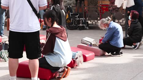 people engaged in prayer at a temple