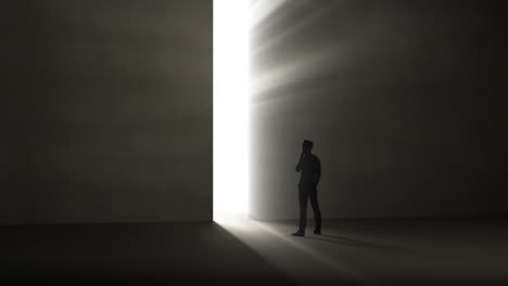 businessman looking at light shining through opening