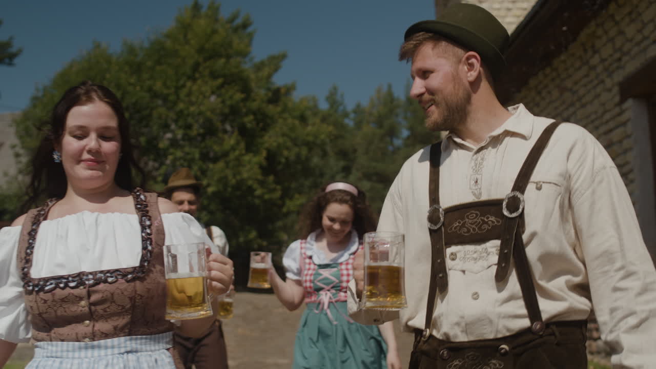 Oktoberfest celebration with people in traditional costumes drinking beer