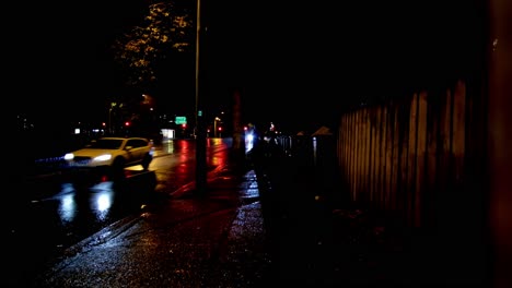 vehicles on a rainy night along a suburban sydney street