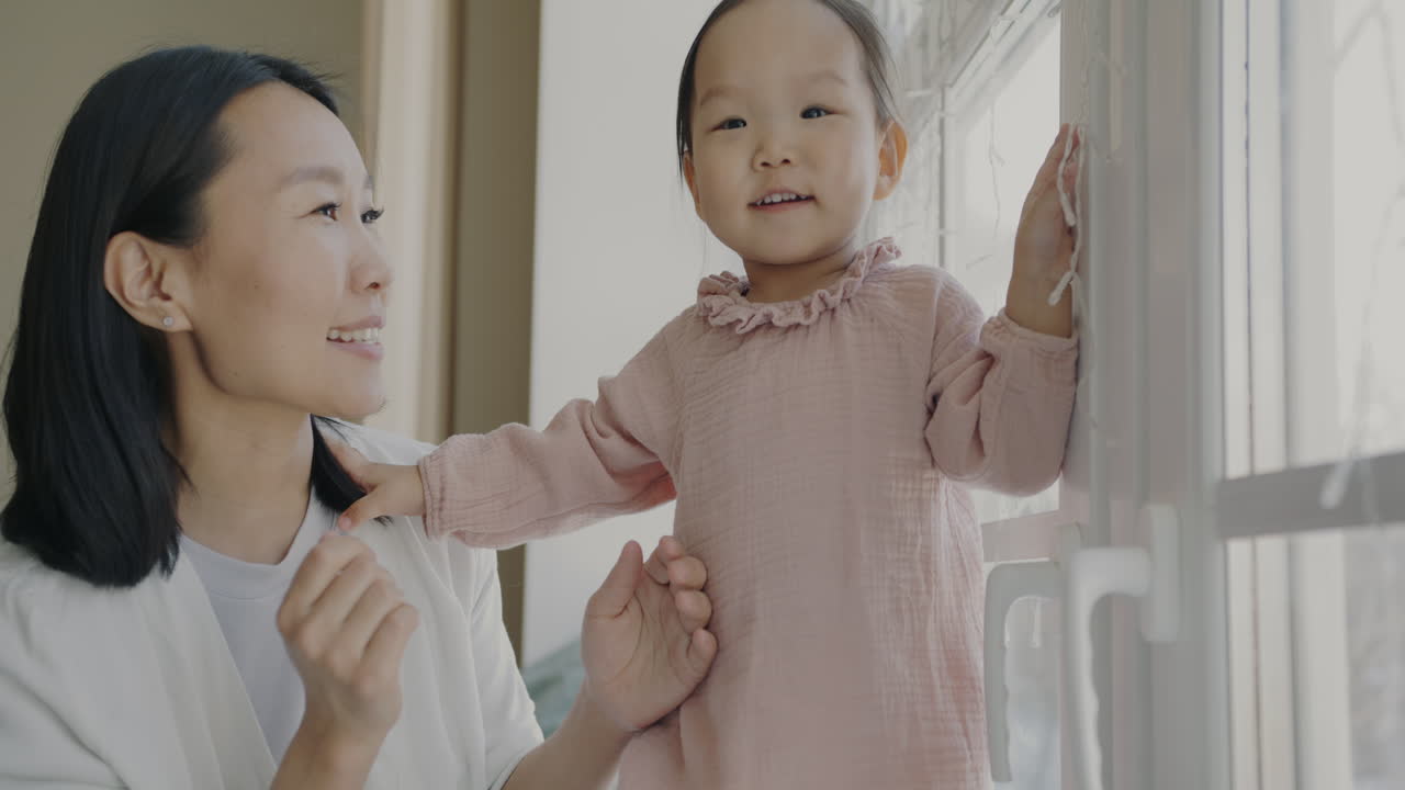 Mother and Daughter Playing by Window
