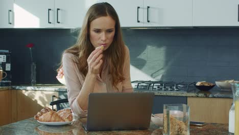 business woman watching video in luxury kitchen. woman getting bad news.