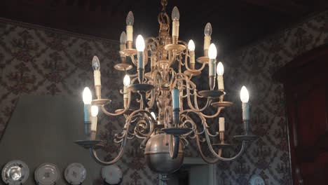 slow rotating shot of a stunning antique chandelier hanging from the ceiling