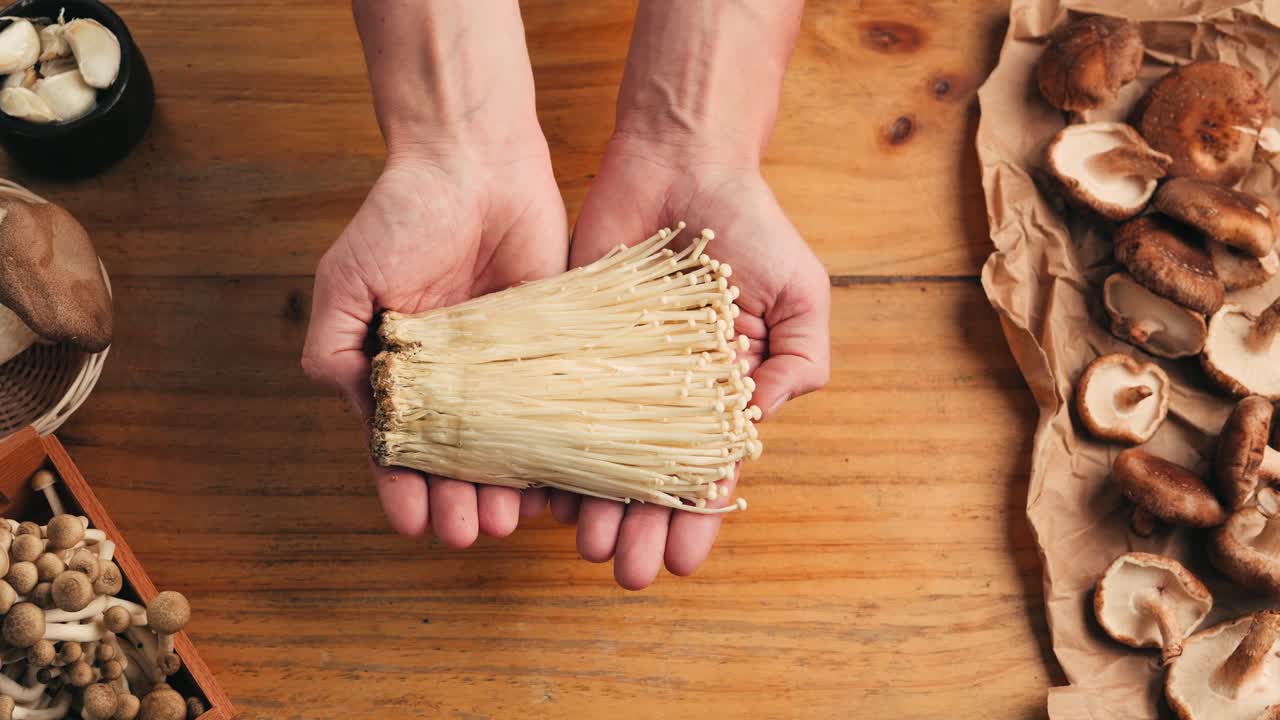 Hands Holding Bunched Mushrooms
