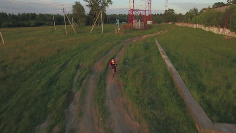 teenager riding bike in the country aerial view