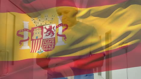 animation of spain flag, caucasian surgeon adjusting gloves while rushing towards operation theater
