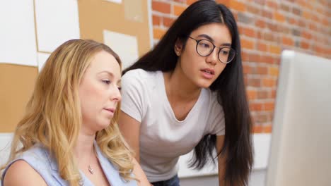 Businesswomen-discussing-over-computer-in-office-4k