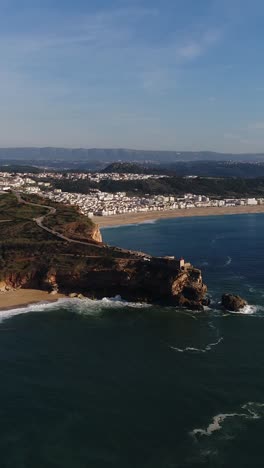 panoramic aerial view of a coastal town with a lighthouse and beach