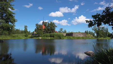 A-timelapse-view-of-the-Museum-fortress-Korela-producing-a-profound-effect-through-its-fascinating-view-of-the-lake-and-passing-clouds,-Russia