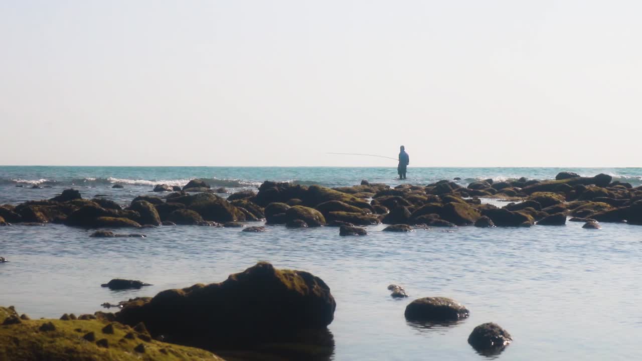 One person fishing on the coast of Saint Martin's Island, Bangladesh, wide shot