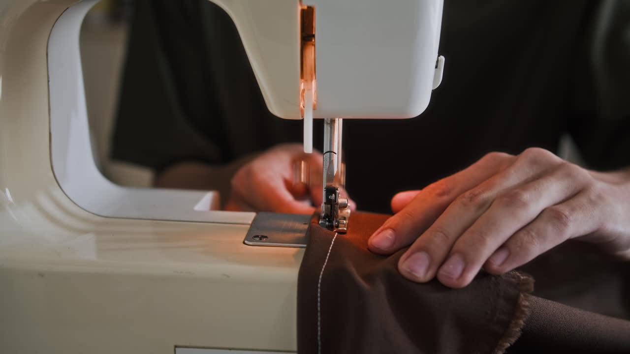 Hands of Seamster Using Sewing Machine