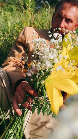 man relaxing in a field with flowers